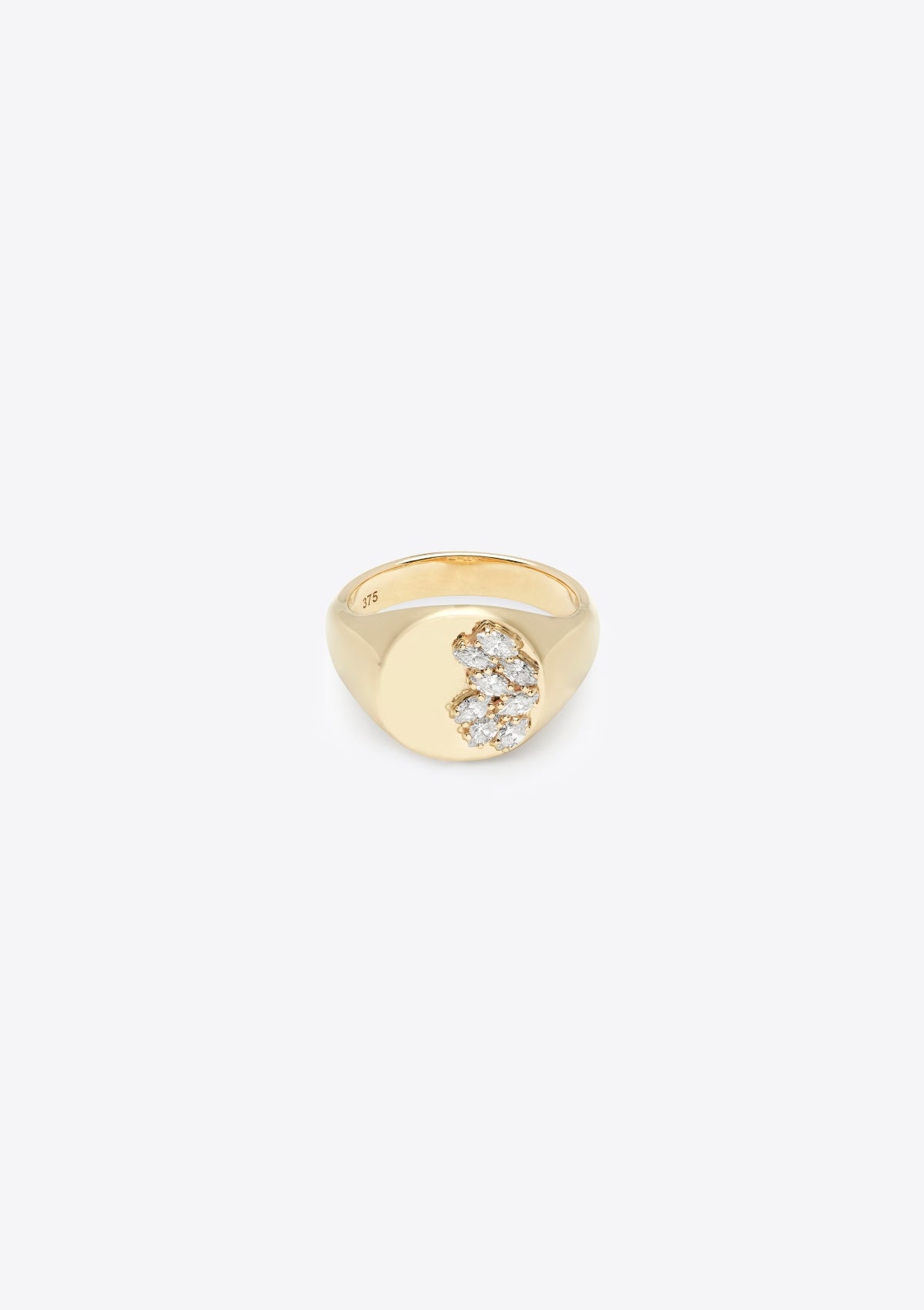 round gold signet ring, 8 small marquise diamonds across half the face, the other half plain gold. front on against a grey background