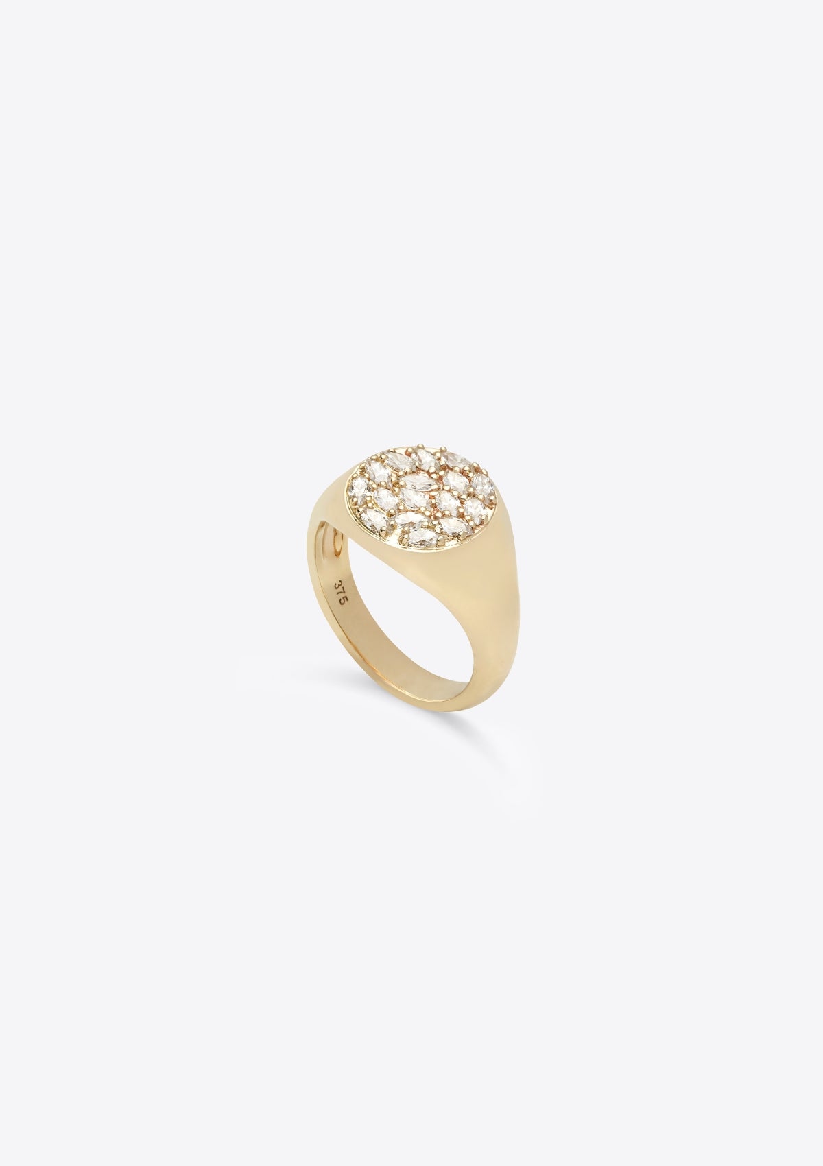 round gold signet with the face covered in closely set marquise diamonds. front on, grey background