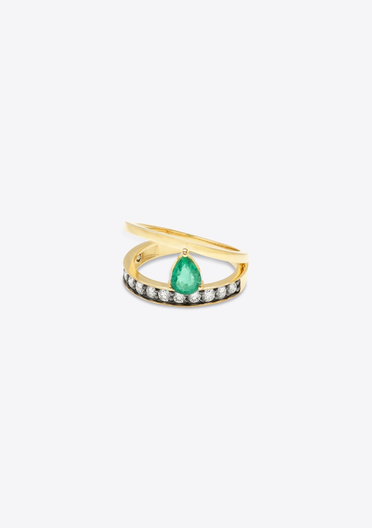 ring with diamond-set gold band with a plain gold band asymmetrically above, joined by a pear emerald. left side, grey background