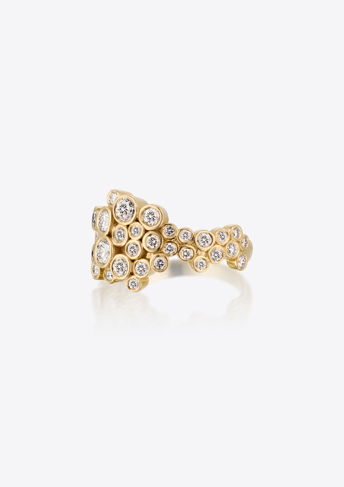 left side view of gold ring with small and large diamonds clustered together against a white background