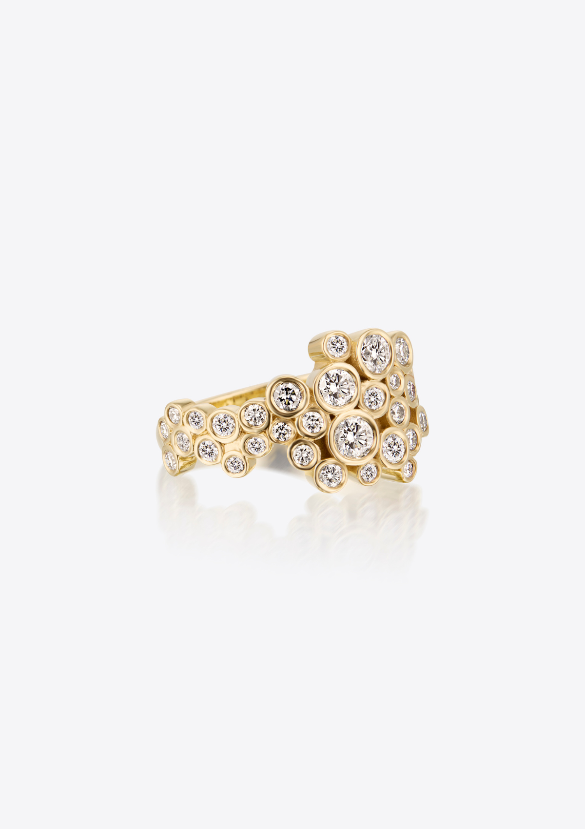 Side view of gold ring with diamonds in various sizes on a white background