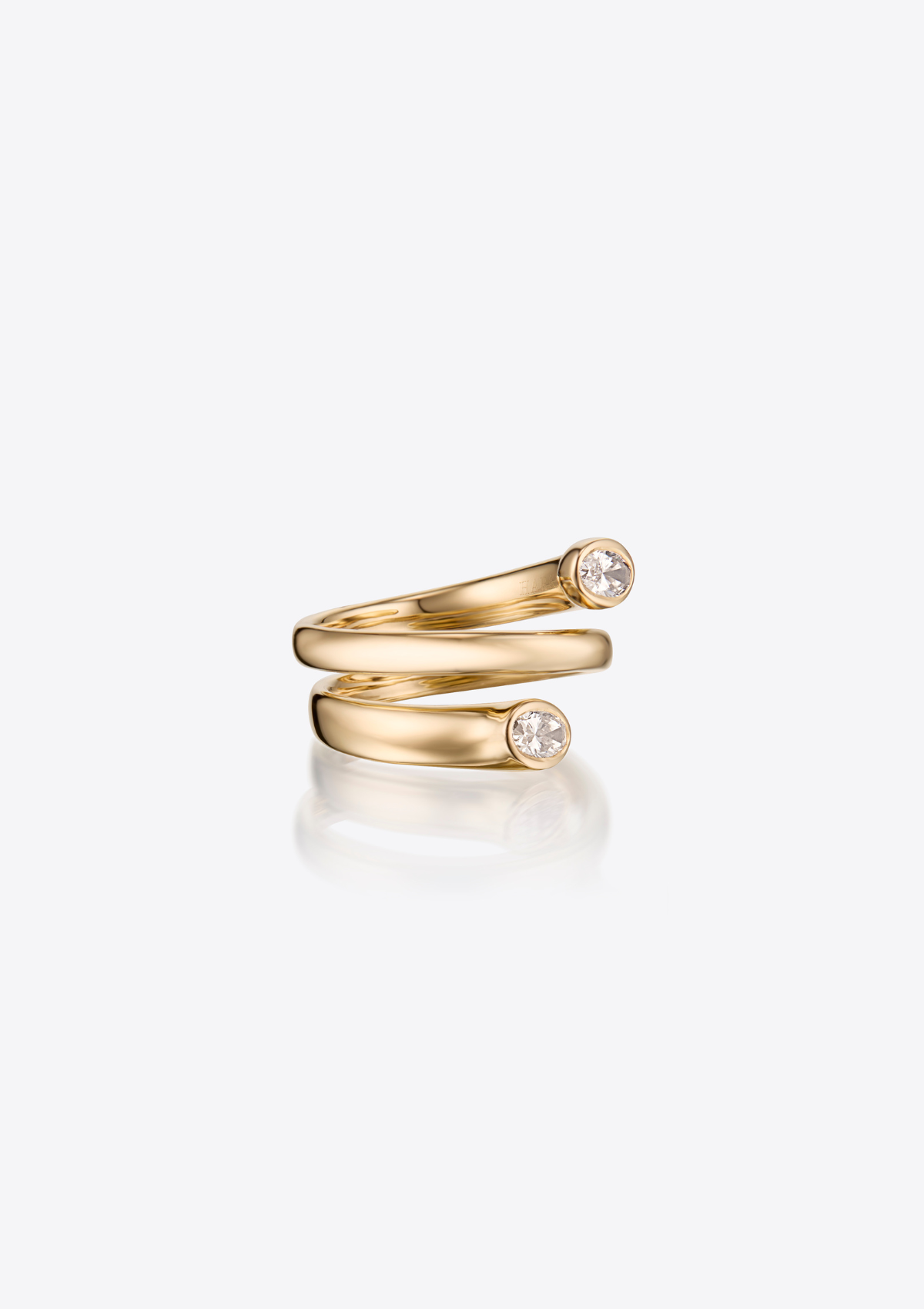 side view of gold ring that wraps twice around finger with 2 oval diamonds