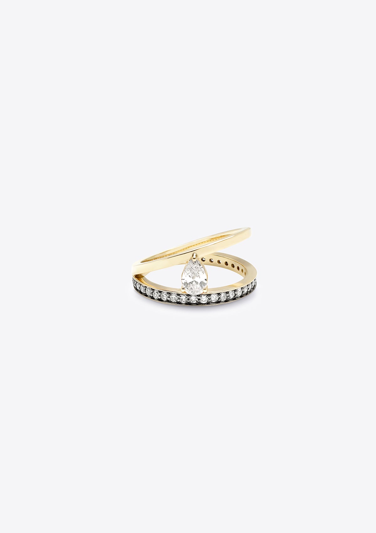 small diamond-set gold band with a plain gold band asymmetrically above, joined by a pear diamond. top down view, grey background