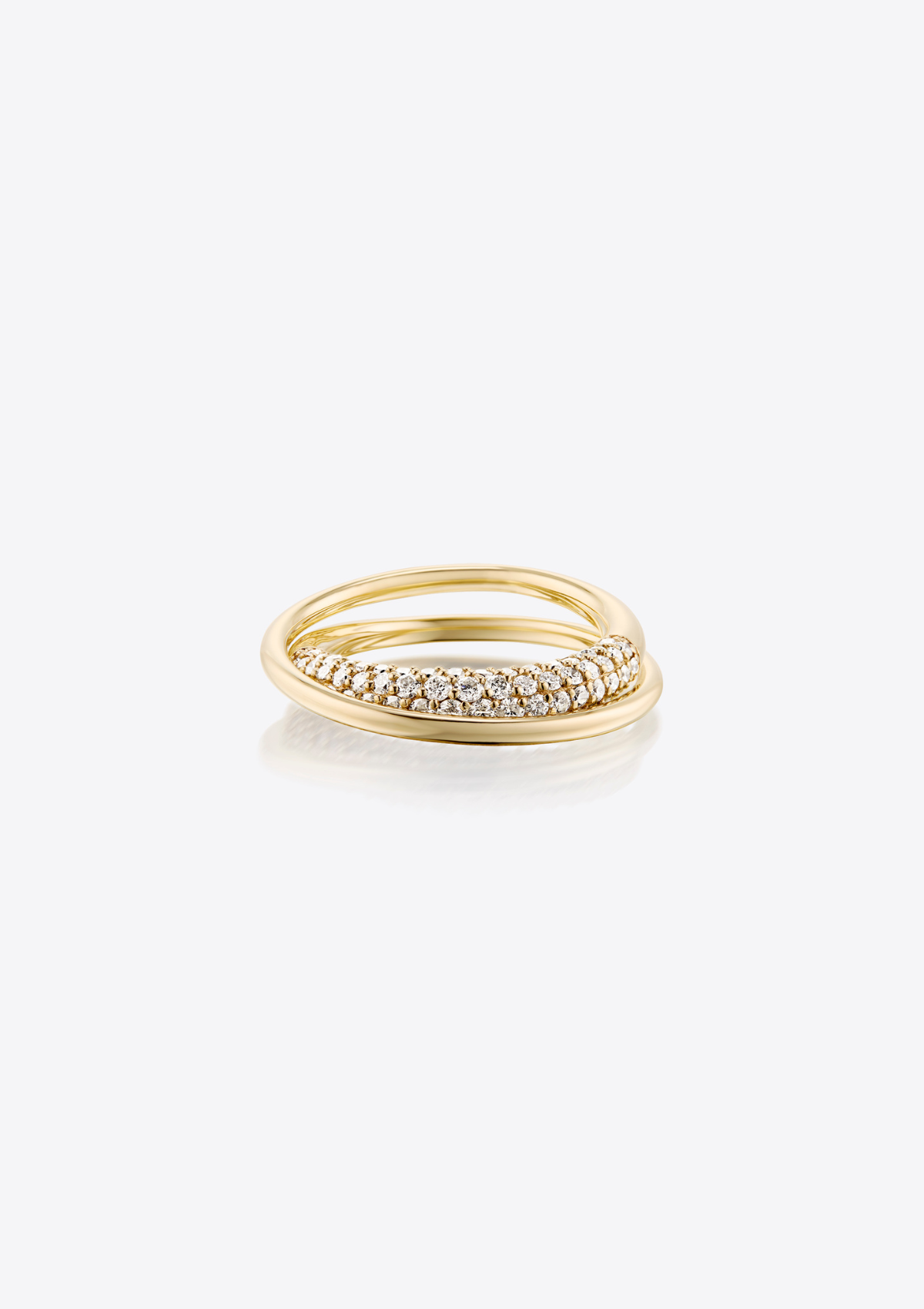 Gold sculptural infinity loop ring with pave diamonds on a grey background