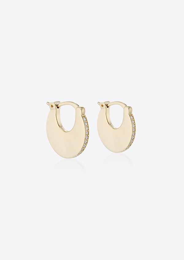 Pair of gold solid hoop earrings with pave diamonds on a grey background pictured on the side