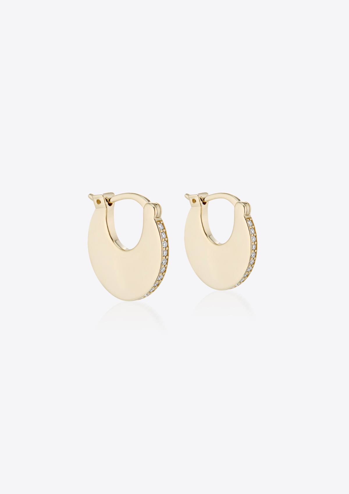Pair of gold solid hoop earrings with pave diamonds on a grey background pictured on the side