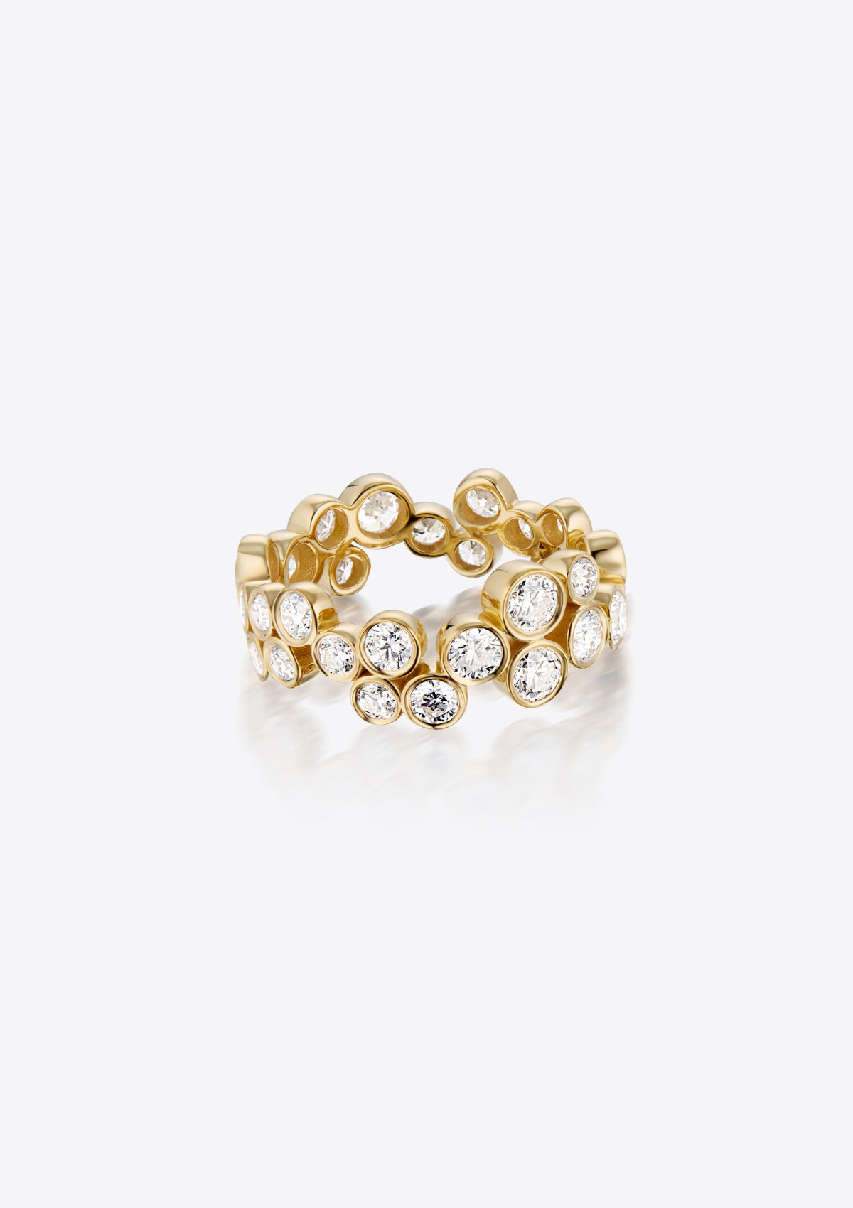 A gold band ring featuring a continuous row of small round diamonds in bezel settings, on a clean grey background with a soft reflection.
