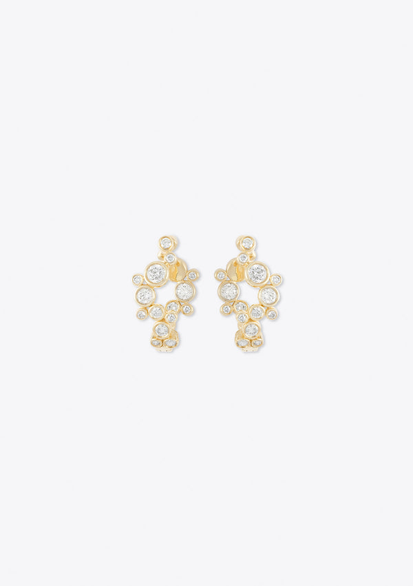 front view of yellow gold round diamond hoop earrings in an asymmetric curve design on a grey background