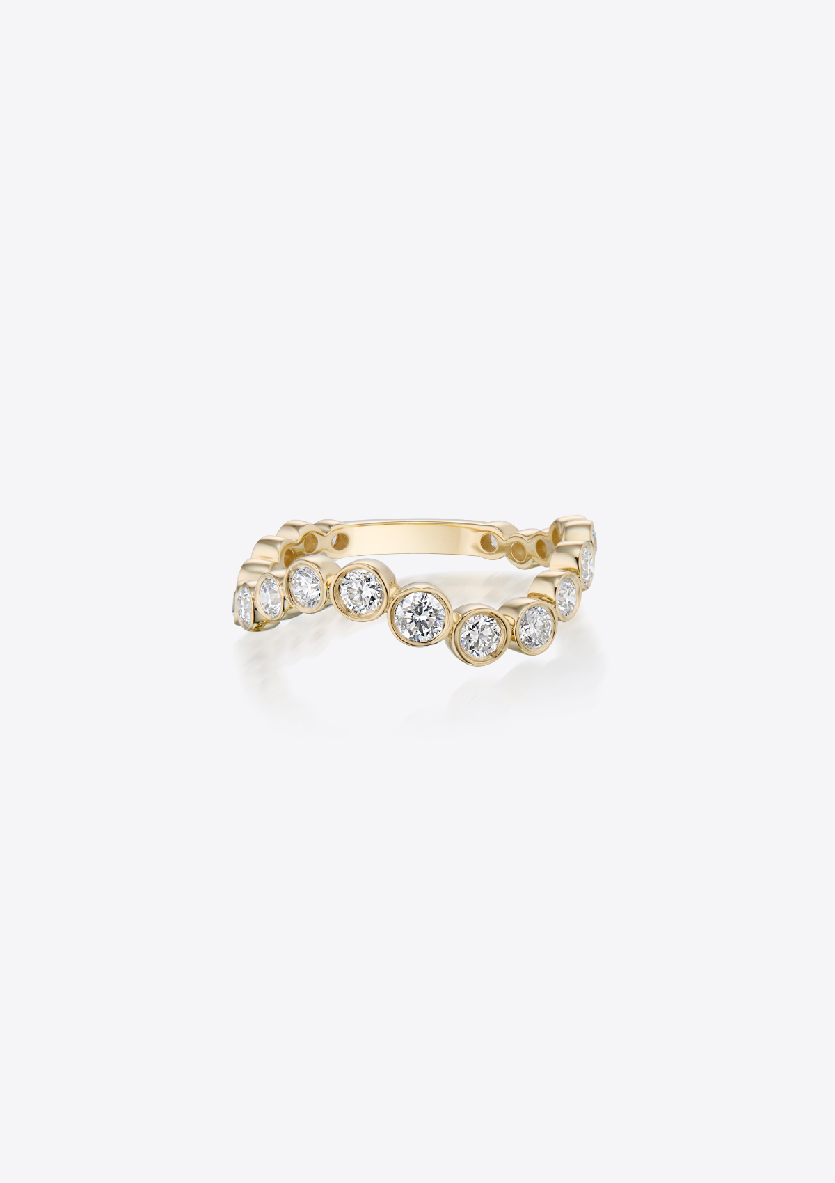 Gold ring with curved graduating diamonds on a grey background. front view