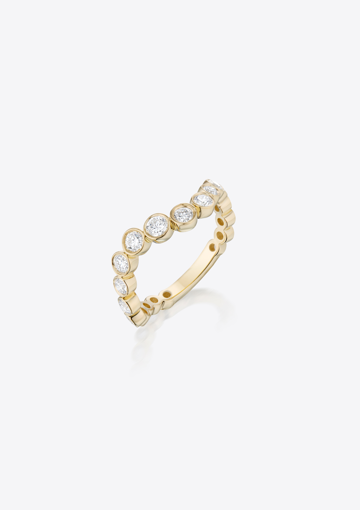 Gold ring with curved graduating diamonds on a grey background. front view
