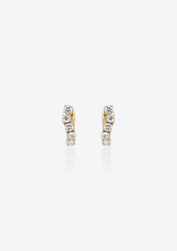 gold diamond huggies in a curved shape against a grey background. front view